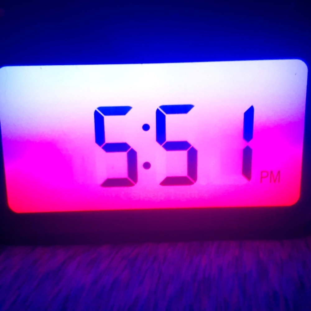 Digital alarm clock with a radio and chargeable colors